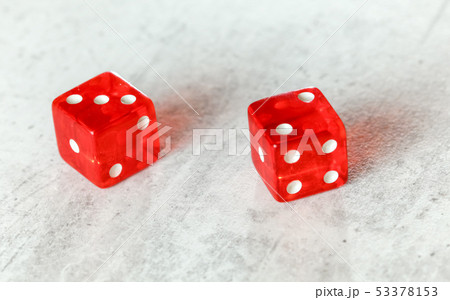 Two translucent red craps dices on white board showing Fever Five Little Phoebe number 3 and 2  53378153