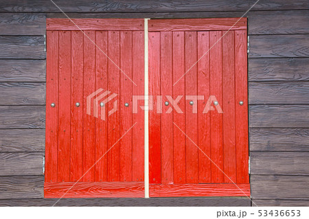 Red window brown wood wall. 53436653