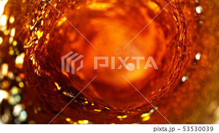 Detail of cola, tea or hard spirit beverages whirl 53530039