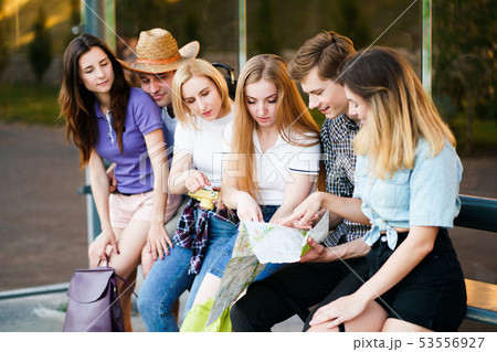 Tired tourists rest at bus stop Tired tourists rest at bus stop 53556927