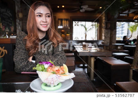 woman eating salmon sashimi spicy salad in woman eating salmon sashimi spicy salad in 53562707