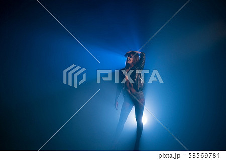Brunette wearing black jacket and jeans shorts Brunette wearing black jacket and jeans shorts 53569784