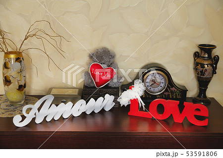 Wooden inscription with the words love in the room on the dresser Wooden inscription with the words love in the room on the dresser 53591806