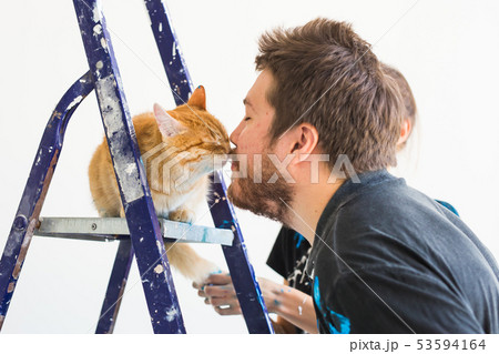 People, renovation, pet and repair concept - Portrait of funny guy with cat doing redecoration in 53594164