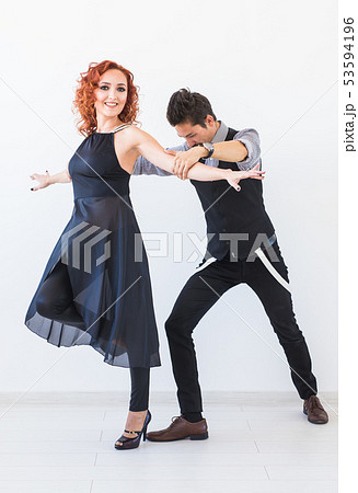 Social dance, bachata, kizomba, tango, salsa, people concept - Young couple dancing over white Social dance, bachata, kizomba, tango, salsa, people concept - Young couple dancing over white 53594196