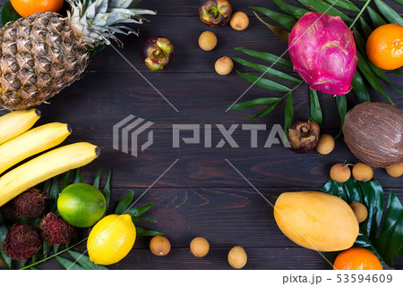 Tropical Fruits and Berry Raw Eating Diet Concept Food frame with copy space over wooden background Tropical Fruits and Berry Raw Eating Diet Concept Food frame with copy space over wooden background 53594609