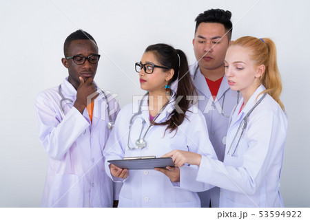 Studio shot of diverse group of multi ethnic doctors looking at  53594922