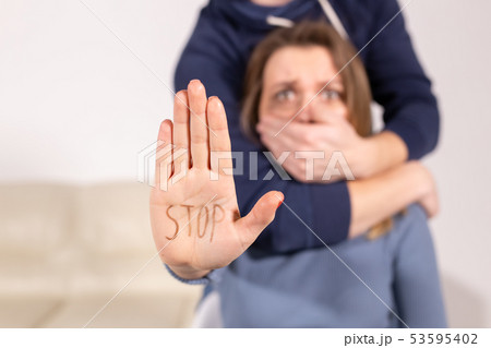 Alcoholism, abuse and problem concept - Sad woman shows stop sign, stop domestic violence. Man 53595402