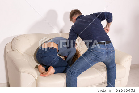 people, abuse and violence concept - angry aggressive husband trying to hit his wife 53595403