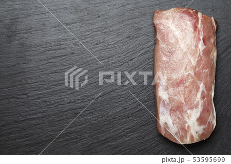 raw pork on black background 53595699