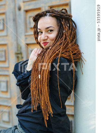 dreadlocks fashionable girl posing at old wooden 53595919
