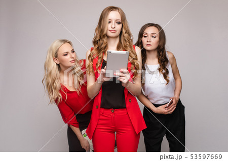 Three ladies using gadgets. Three gorgeous elegant 53597669