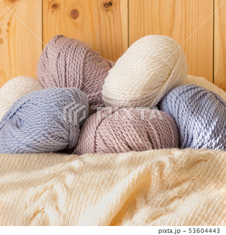 Thin fluffy skeins of wool for knitting a pale pink, blue and beige colors Thin fluffy skeins of wool for knitting a pale pink, blue and beige colors 53604443