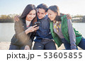 Group of trendy Asian teens with mobile phone outdoors, having fun, digital generation 53605855