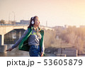 teenager girl 16 years old listening to music on headphones in phone 53605879