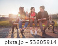 Group of Asian teenage students schoolchildren sitting on a bench in the park and preparing exams 53605914