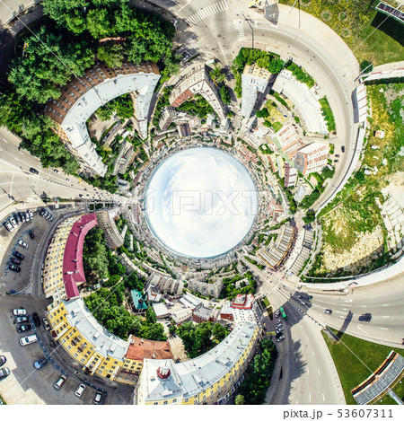 Aerial city view with crossroads and roads, houses, buildings, parks and parking lots. Sunny summer 53607311