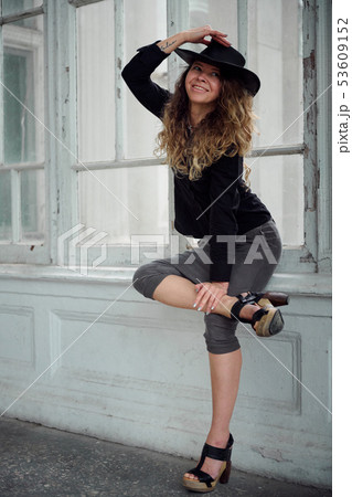fashionable girl dressed in black shirt, hat and fashionable girl dressed in black shirt, hat and 53609152