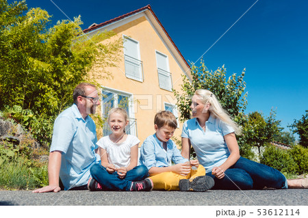 Family in front of their home 53612114