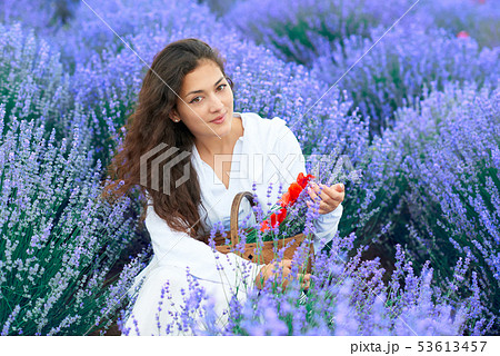 young woman with poppy is in the lavender flower 53613457