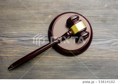 Judge's gavelon an old vintage wooden table 53614102