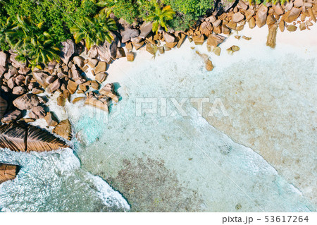 Aerial drone bird eye shot of beautiful paradise tropical Anse Cocos beach at La Digue, Seychelles Aerial drone bird eye shot of beautiful paradise tropical Anse Cocos beach at La Digue, Seychelles 53617264