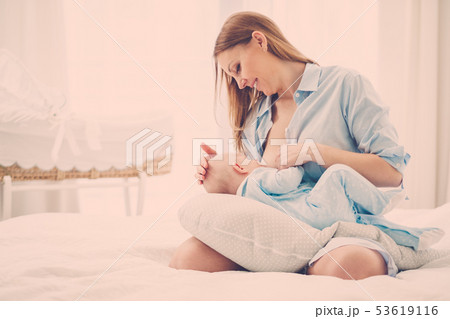 Happy middle aged mother breast feeding her baby Happy middle aged mother breast feeding her baby 53619116