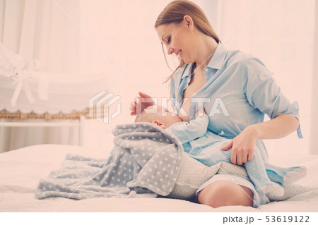 Happy middle aged mother breast feeding her baby Happy middle aged mother breast feeding her baby 53619122