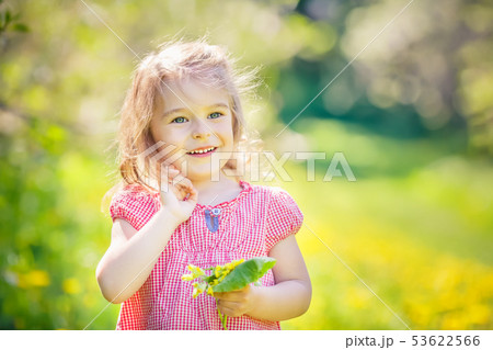 Happy little girl in spring sunny park 53622566
