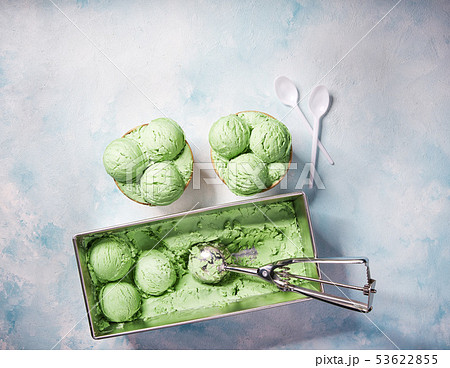 Pistachio ice cream scooped out of container, top Pistachio ice cream scooped out of container, top 53622855