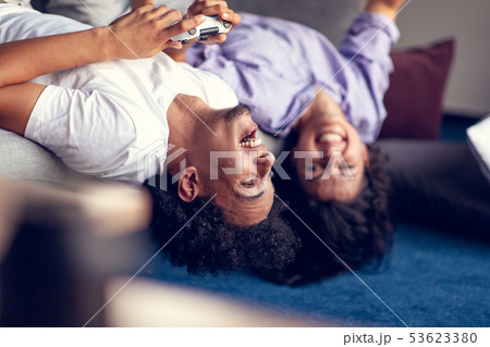 Young smiling couple playing videogames at home. Young smiling couple playing videogames at home. 53623380