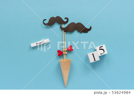 Couple paper mustache props fastened heart in ice 53624984