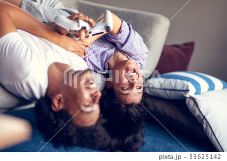 Young smiling couple playing videogames at home. Young smiling couple playing videogames at home. 53625142
