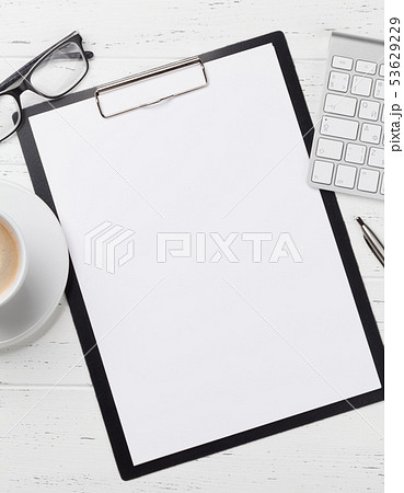 Office workplace table with blank paper page Office workplace table with blank paper page 53629229