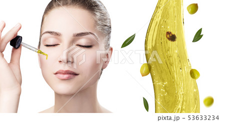 Young beautiful woman near splash of olive oil. 53633234