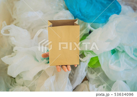 Paper bag amid a pile of plastic bags. Zero waste concept. The concept of World Environment Day 53634096