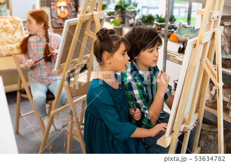 Active children feeling excited while drawing in art school 53634782