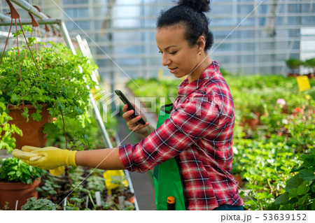 Black woman working in a botanical garden 53639152