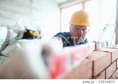 Serious man in hardhat 53639825