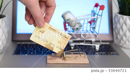 Male hand holding a credit card near the Male hand holding a credit card near the 53640721