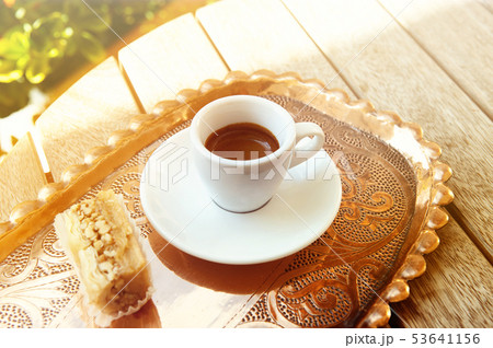 White cup of espresso coffee on wooden table background. White cup of espresso coffee on wooden table background. 53641156