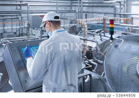 man in a white robe and a cap make a configure the digital screen 53644956