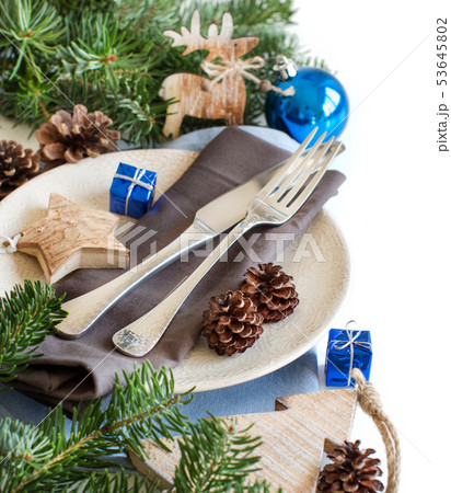 Blue and brown Christmas table setting with rustic 53645802