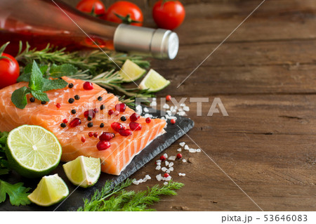 Salmon with vegetables, olive oil and herbs 53646083