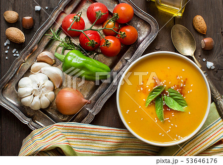 Fresh pumpkin soup and vegetables on a wooden 53646176