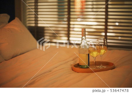 Two glasses of white wine in bed on the blurred Two glasses of white wine in bed on the blurred 53647478