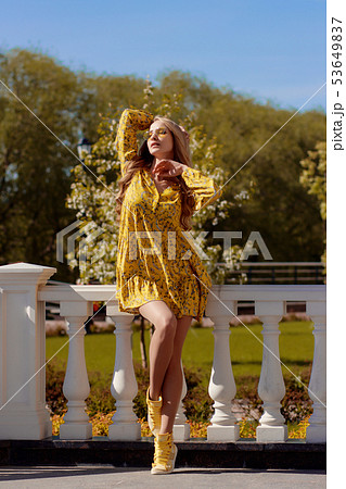 Beautiful blonde in a yellow dress on a Sunny day Beautiful blonde in a yellow dress on a Sunny day 53649837