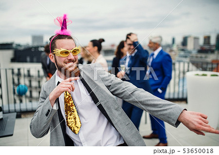 A group of joyful businesspeople having a party outdoors on roof terrace in city. A group of joyful businesspeople having a party outdoors on roof terrace in city. 53650018