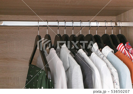 Female different clothes on black wooden hang 53650207