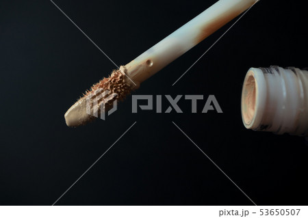 Make up applicator and tube of beige concealer 53650507